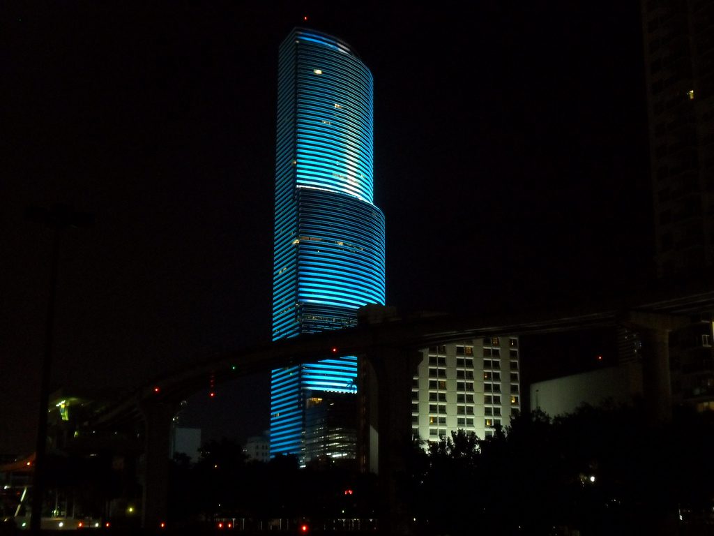 A building lit up at night with blue lights.